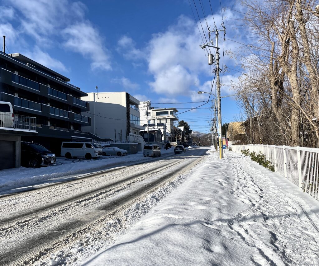 北海道冬季街道景色，藍天陽光與積雪構成清新明亮的城市風景
